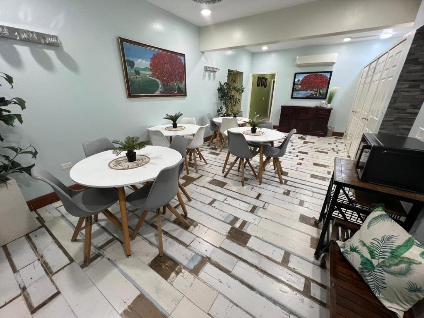 The light-filled breakfast room at BethsAida, tables ready for a working morning