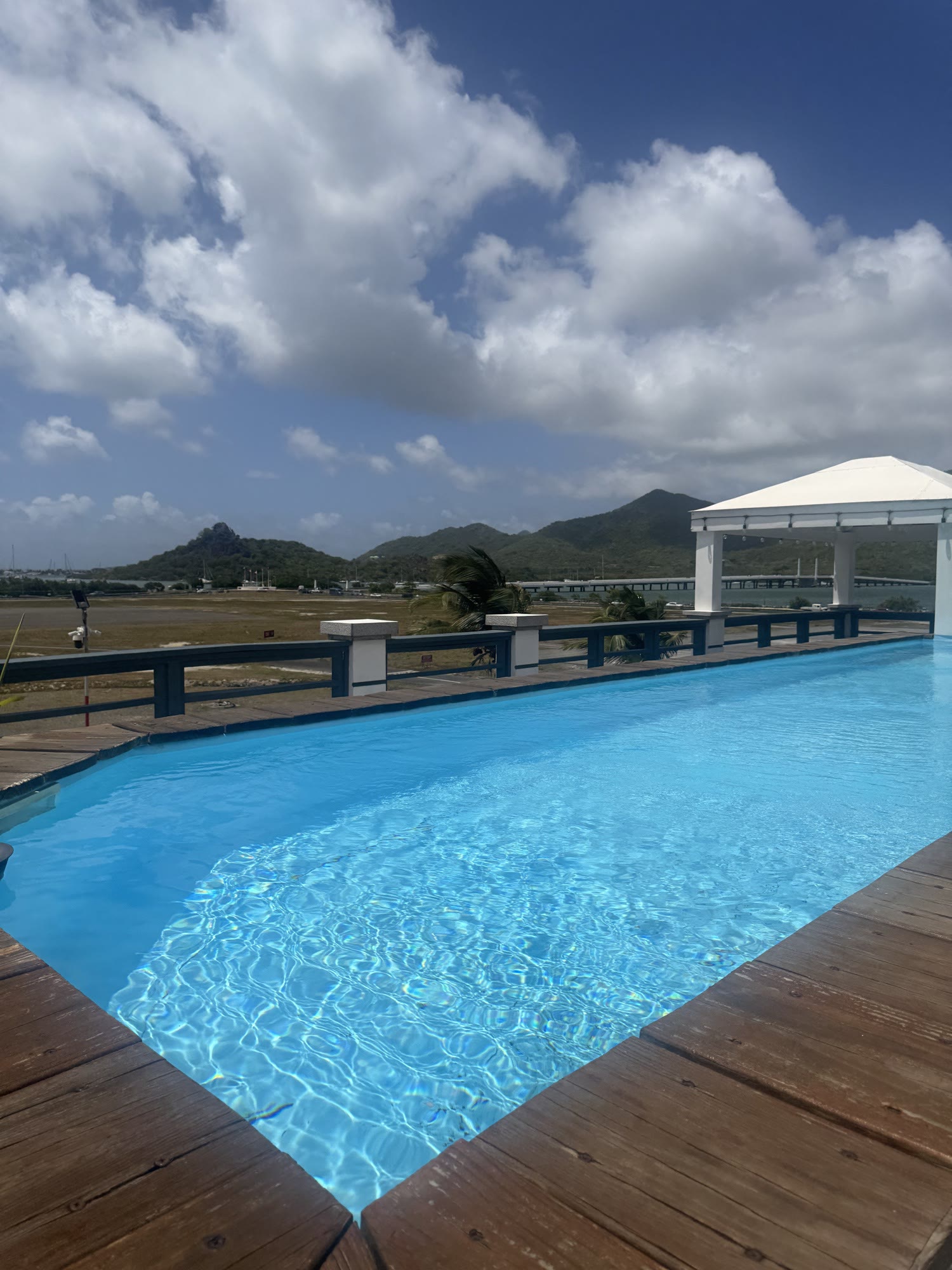 The rooftop pool deck and the SXM runway beyond, where the runway happy hour unfolds